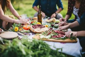 Eine Gruppe von Freunden macht ein Picknick mit gesunden Lebensmitteln